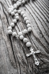 Rosary on old wooden background
