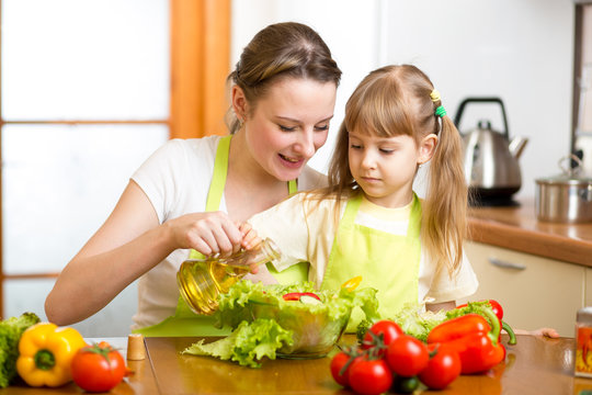 Happy woman and child preparing healthy food together