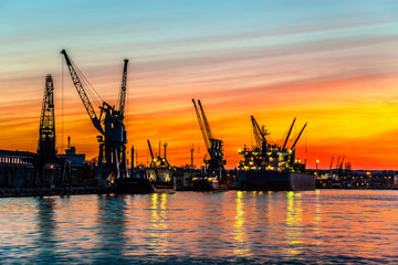 Fototapeta premium Port of Gdansk during the orange sunset.