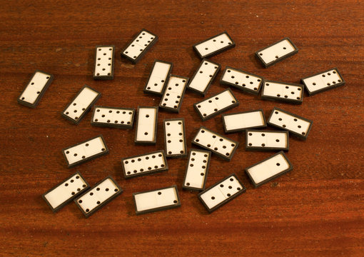 white dominoes scattered on the table.