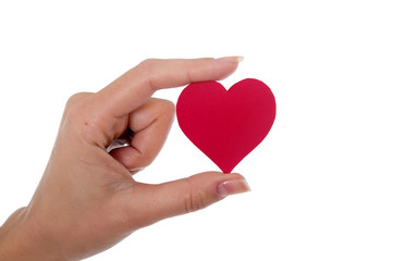 Obraz premium red heart in a womans hand on white background
