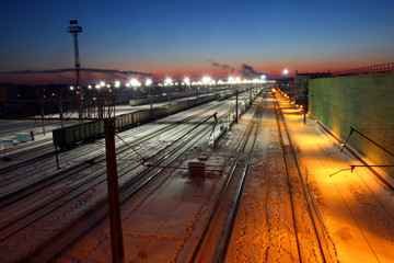 Fototapeta na wymiar Railway station in winter at sunrise