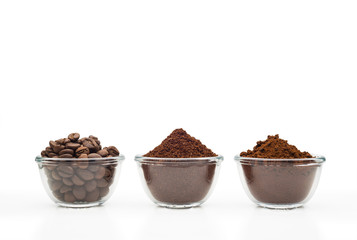 Coffee beans, ground coffee and instant coffee, in little glass cups on a clean white background