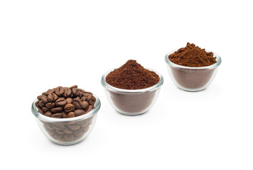 Coffee beans, ground coffee and instant coffee, in little glass cups on a clean white background
