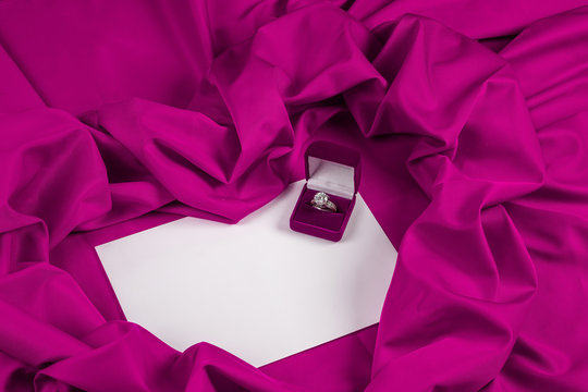 love card with diamond ring on a purple fabric