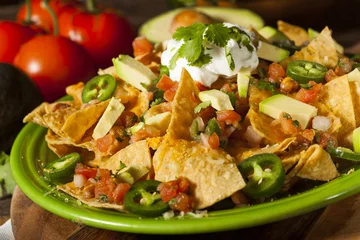 Tuinposter Homemade Unhealthy Nachos with Cheese and Vegetables © Brent Hofacker