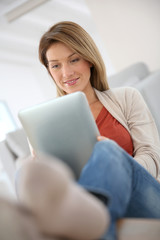 Woman at home connected on internet with tablet