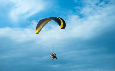 Paragliding fly on blue sky