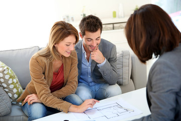 Couple meeting architect for house construction