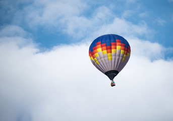 Fototapeta na wymiar Multicolored Balloon in the blue sky