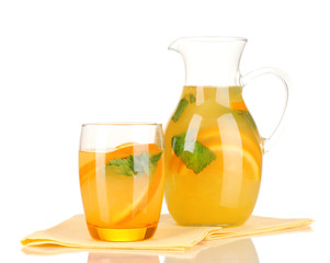 Orange lemonade in pitcher and glass isolated on white
