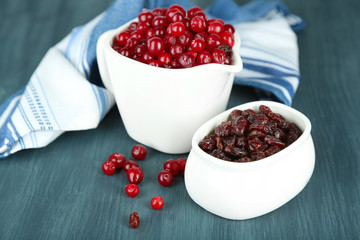 Fresh and dry cranberry in pitchers and bowl