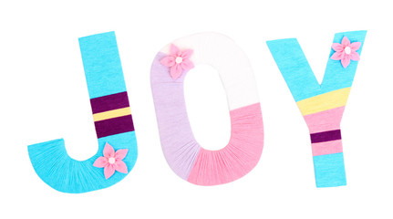 Word Joy created with brightly colored knitting yard isolated