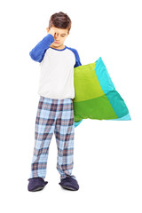 Full length portrait of sleepy kid holding a pillow