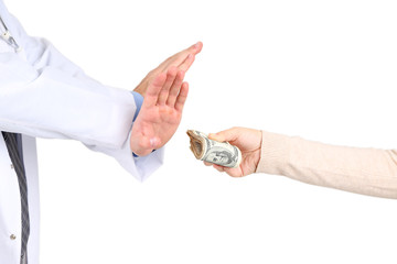 Male Doctor receiving money from patient, isolated on white