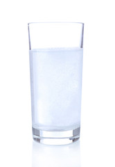 Glass with efervescent tablet in water with bubbles isolated
