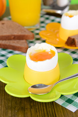 Boiled eggs in egg cups on table close-up