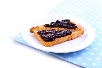 Delicious toast with jam on plate isolated on white