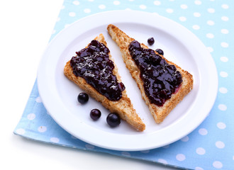 Delicious toast with jam on plate close-up