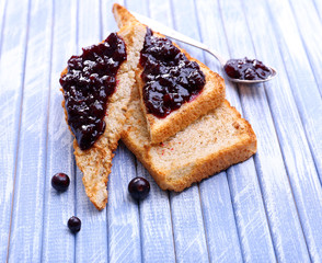 Delicious toast with jam on table close-up