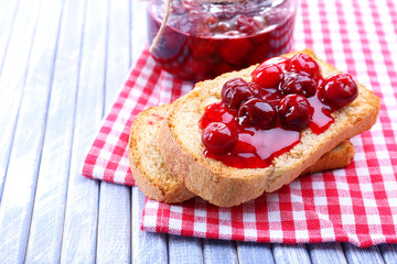 Delicious toast with jam on table close-up