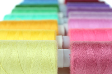 Colored spools of threads close up