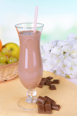 Milk shake on table on light blue background