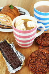 Cup of cappuccino and sweets close up