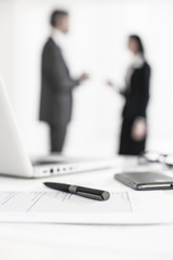 silhouette of a business people  with symbolic business objects