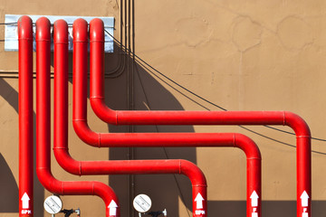 splinker alarm system red water pipe brown wall outdoor