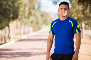 Young Latin man in a running track