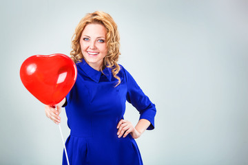 blonde woman holding ballons