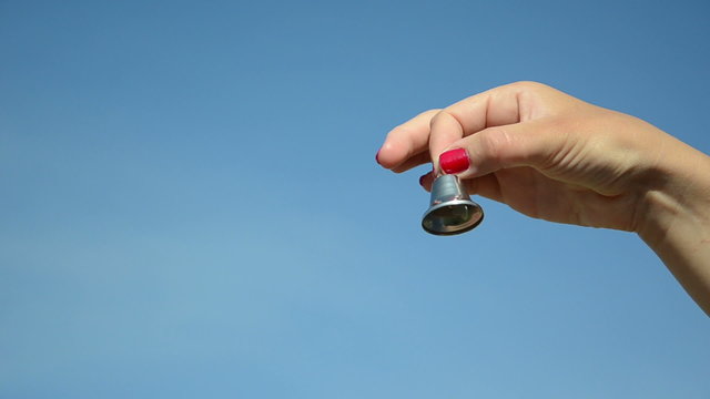 hand shake jingle small silver bell on blue sky