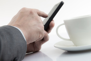 Fototapeta na wymiar Businessman Using Cell Phone with coffee cup