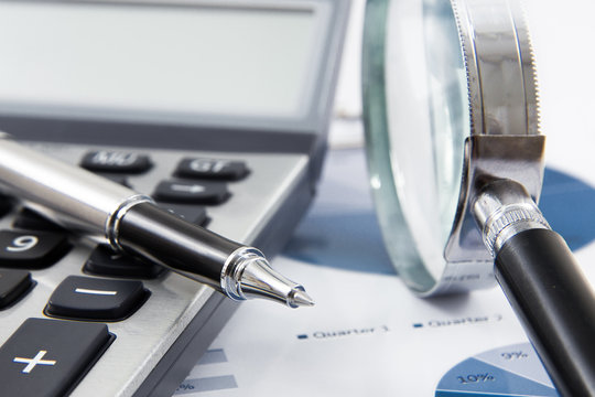 magnifying glass on the business report