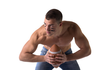 Handsome, serious young man shirtless, holding american football