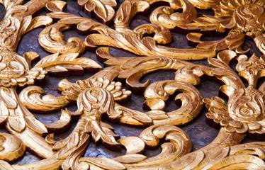 Ancient golden carving wooden window of Thai temple. Thailand