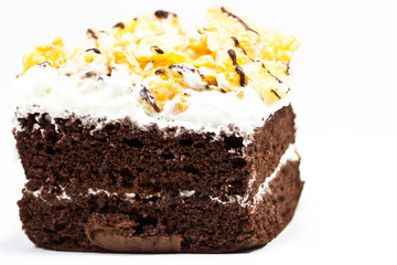 Frosted chocolate brownie on white background . Macro with extre