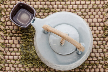 Cup of tea and teapot on wooden
