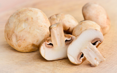 Champignon on wooden background
