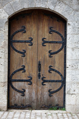 Beautiful old wooden door with iron ornaments