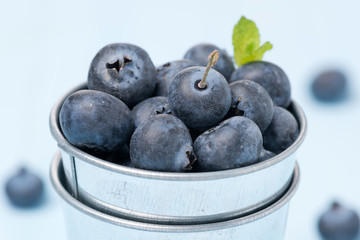 Fresh blueberries in a metal bucket, close-up, selective focus