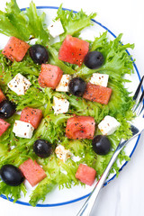 salad with watermelon, feta cheese and olives on the plate
