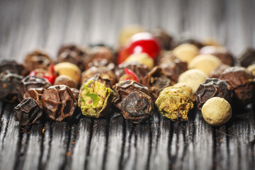 pepper corns on a wooden board