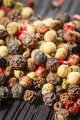 pepper corns on a wooden board