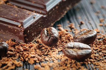 Fresh roasted coffee beans and stack of brown chocolate
