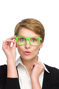 Surprised beautiful young woman in green glasses.