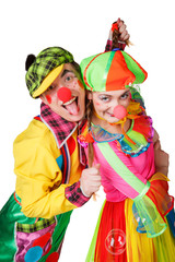 Two clown smiling isolated over a white background