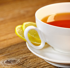 Cup of tea with lemon on the wooden table