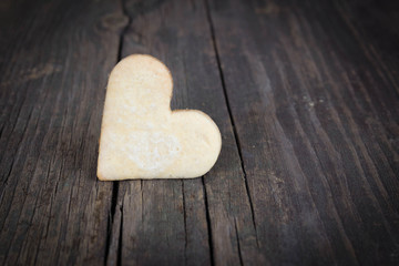 Heart of the cookies and the wooden background.